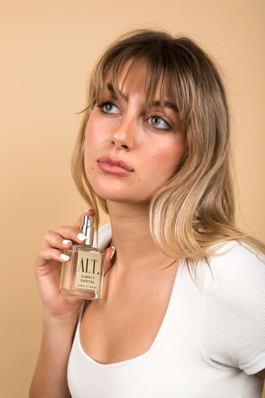 Woman applying ALT. fragrance
